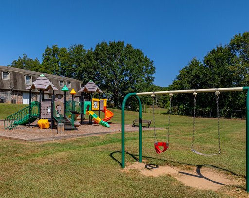 Colorful playground with children and parents in park